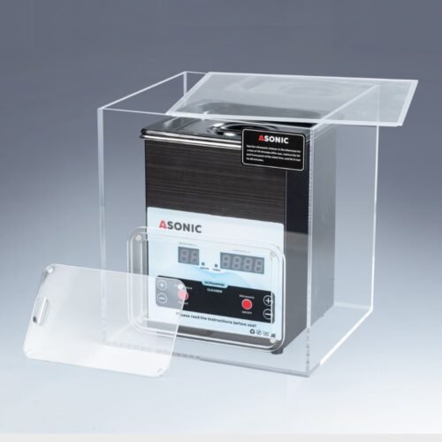 Otwarta skrzynka wyciszająca zawierająca myjkę ultradźwiękową ASONIC o pojemności 2 l, zaprojektowaną w celu zmniejszenia hałasu podczas pracy.